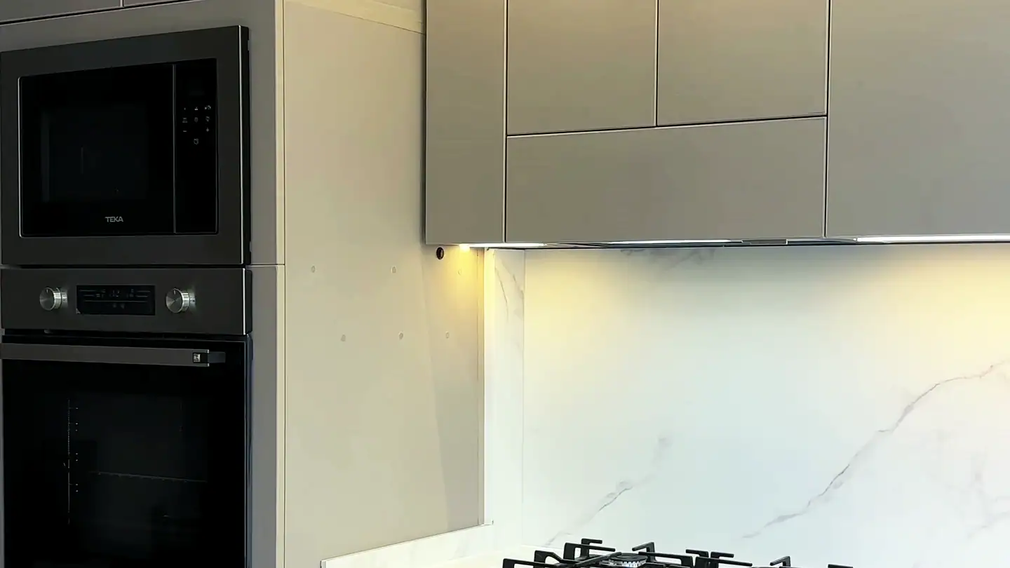 Smėlio spalvos matiniai fasadai be rankenų ir LED apšvietimas